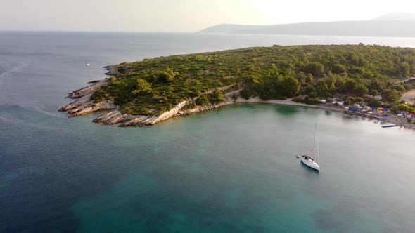 View From Above Aerial View of a Boat Sailing on a Transparent and Turquoise Sea