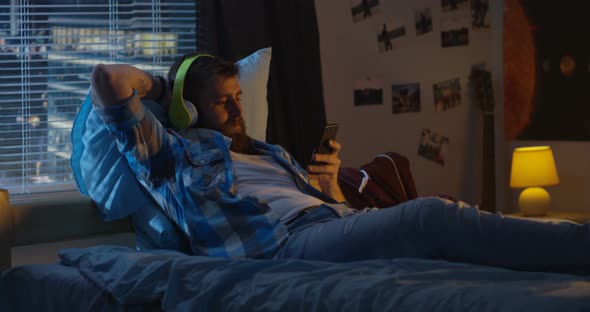 Man Having Video Chat in Bed