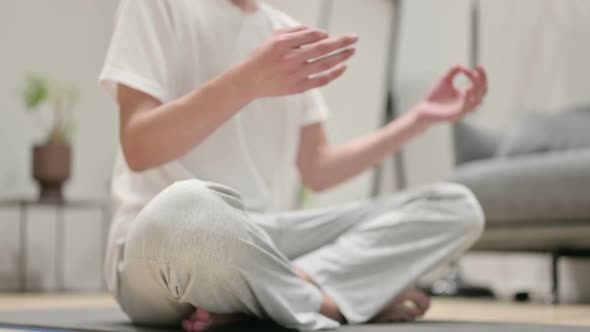 Hands of Asian Man Meditating on Yoga Mat at Home