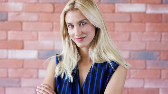 Positive Woman Near Brick Wall