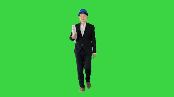 Asian Engineer with Blueprints Walking on a Green Screen Chroma Key