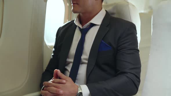 Young Businessman Using Laptop Computer in Airplane