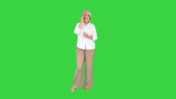 Senior Woman with Smartphone Making a Call on a Green Screen Chroma Key