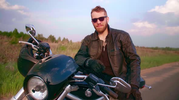 Portrait of a Biker on a Motorcycle Chopper with Sun Glasses