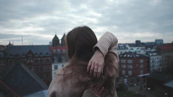 Long Haired Brunette Looking Over City