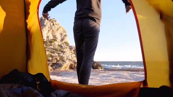 Woman Is Puts Her Shoes While Sits in Camping Tent at Beautiful Beach