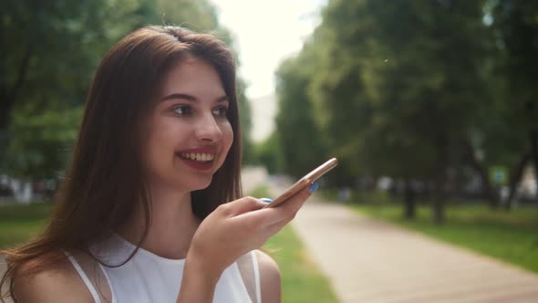 Portrait of Beautiful Brunette Student Woman Outdoor in the Summer, Looking and Smiling Close-up