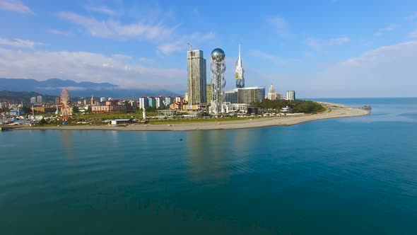 Batumi Seafront Park with Alphabetic Tower Against Cityscape, Aerial Zooming In