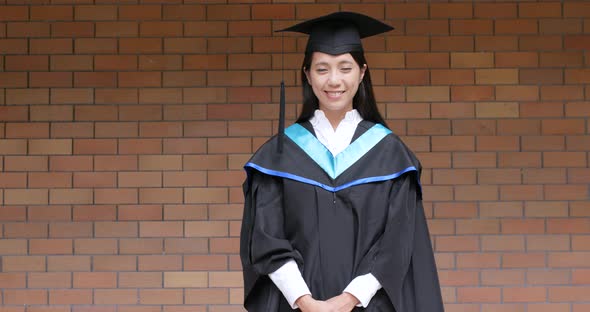 Asian woman get graduation gown