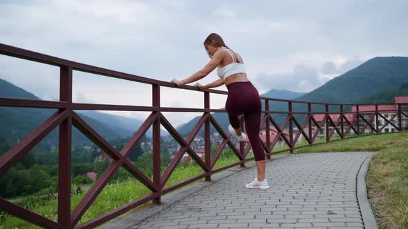 Woman Stretching Legs and Enjoying Nature Scene