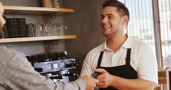 Waiter and customer at counter