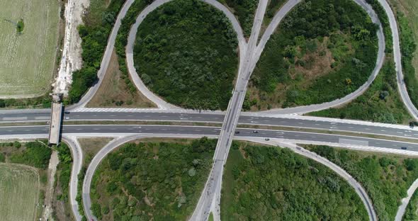 4K aerial footage of highway intersection. Road junction with traffic. Top view