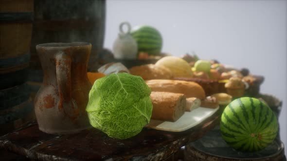 Food Table with Wine Barrels and Some Fruits Vegetables and Bread