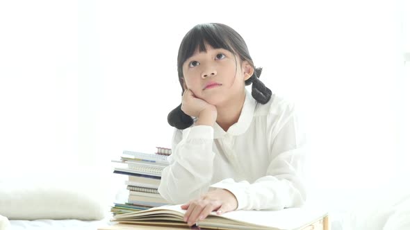 Beautiful Asian Girl Thinking On White Bed