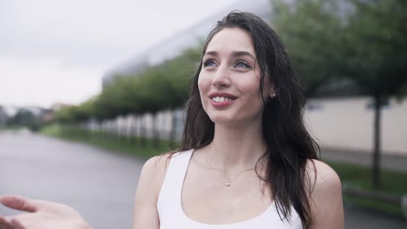 Nice and Pretty Woman Standing in the Rain.