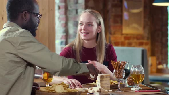 African American man carefully listening to his Caucasian girlfriend