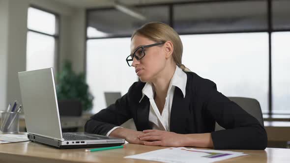 Tired Woman Sleeping in Office, Resting From Monotonous Tasks and Overwork