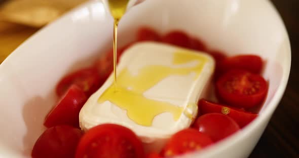 Step by step woman cooking feta cheese pasta, pours olive oil