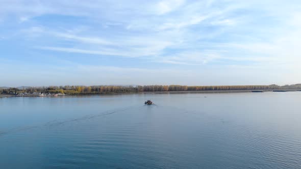 Ferry Boat Cruising And Approaching Towards Riverside At Daytime