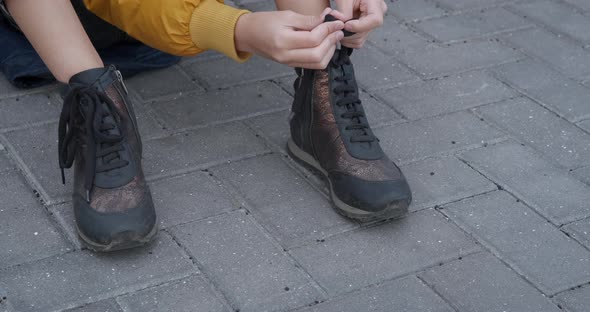 Teen Tying Shoelaces