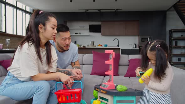United Lovely Asian Family Playing Developing Game