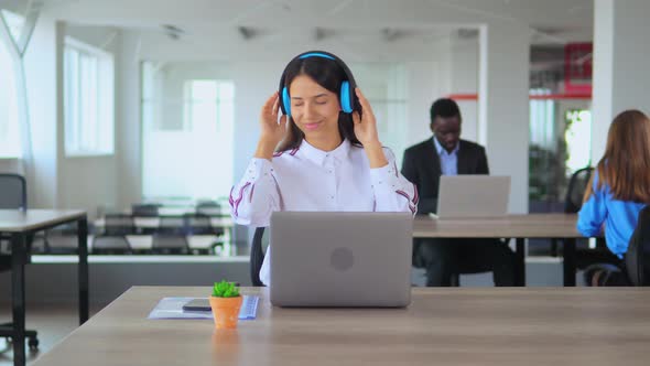 Lady Listening To Music While Working in Office
