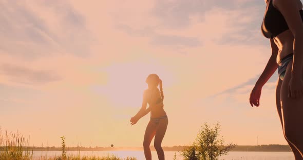 Group of Young Girls Playing Beach Volleyball During Sunset or Sunrise, Slow Motion,