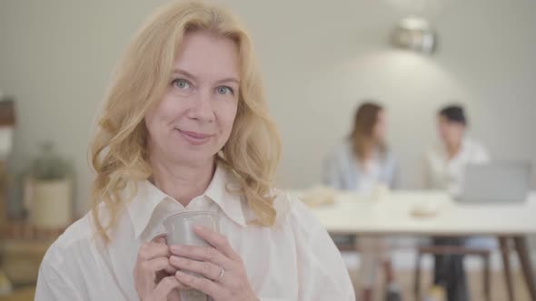 Portrait of Beautiful Mature Caucasian Woman with Blond Hair and Grey Eyes