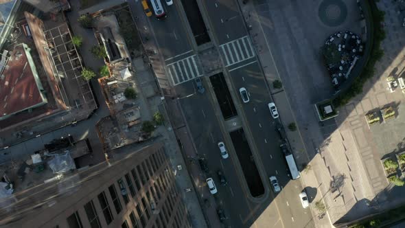 Abstract Lowering Circling Aerial View of City Downtown with Car Traffic in Urban Canyon of Los