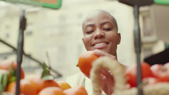 Slow motion shot of woman shopping fresh mandarine