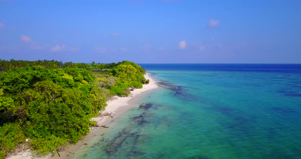 Natural aerial abstract shot of a white sandy paradise beach and aqua blue ocean background in 4K