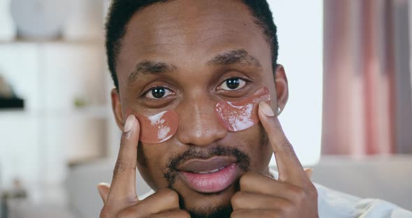 Black-Skinned Guy which Looking Into Camera with Refreshing Collagen Eye-Patches