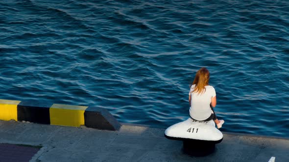 Young Girl Standing on a Pier