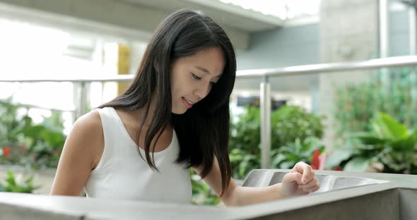 Woman using directory in the shopping mall