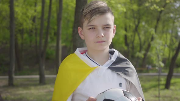 Portrait of a Little Adorable Boy Holding a Soccer Ball. Outdoor Recreation