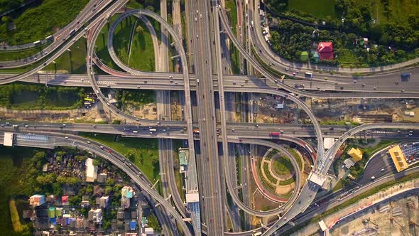 Aerial View of Highway Road Interchange with Busy Urban Traffic Speeding on Road