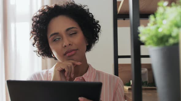 Woman with Tablet Pc Thinking at Home