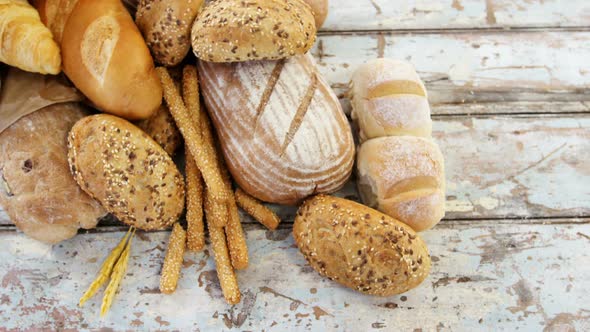 Various bread loaves on wooden table