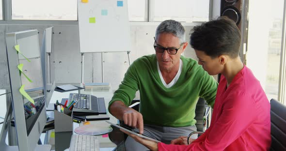 Caucasian Business people discussing over digital tablet at desk in office 4k