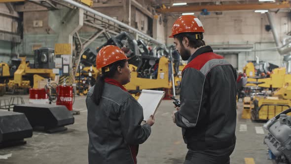 Technicians Talking at Factory