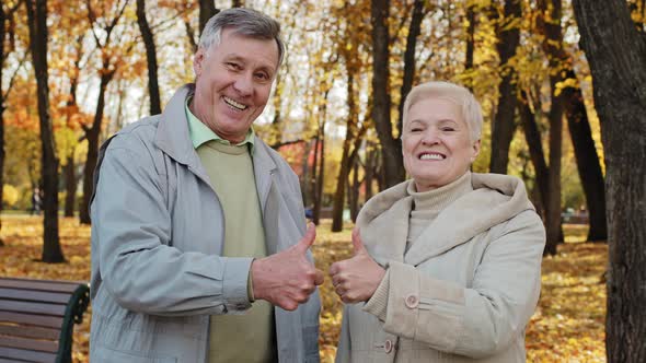 Portrait of Happy Elderly Caucasian Family Wife Husband Senior Grandparents Stand Outdoor in Autumn
