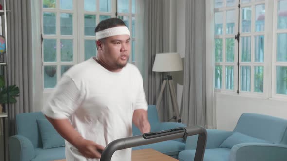 Asian Fat Man Running On A Treadmill At Home At Home