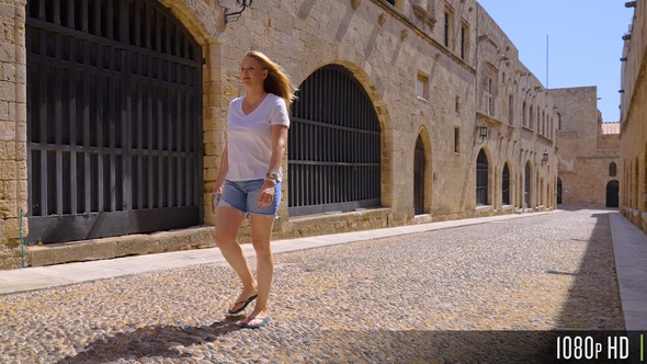 Female walking the Street of the Knights in Rhodes old town, Greece