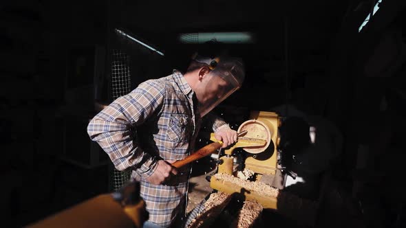 The Owner of a Small Woodworking Business Works in His Workshop on an Order for the Manufacture of