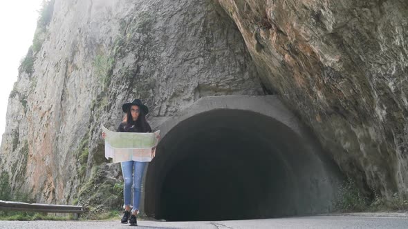 Adorable Girl with Touristic Map in Trigrad, Shiroka Laka, Bulgaria. Happy Women Enjoy Bulgarian