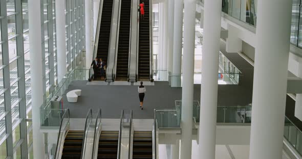 Business people using escalator 