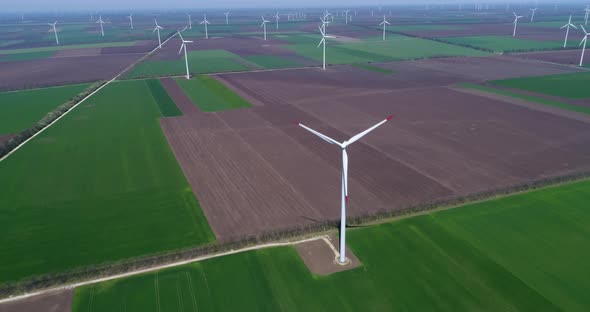 4K aerial drone view of a wind turbine. Windmill for electric power production. Green energy. 