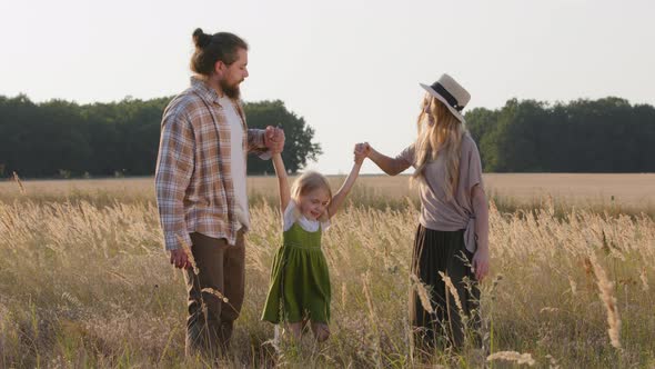 Happy Caucasuan Family Three People Parents with Kid Standing in Wheat Field in Nature Man Woman and