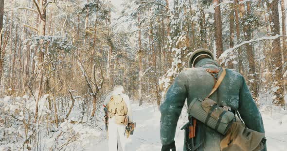 Group Of Reenactors Dressed As German Wehrmacht Infantry Soldiers In World War II Running With