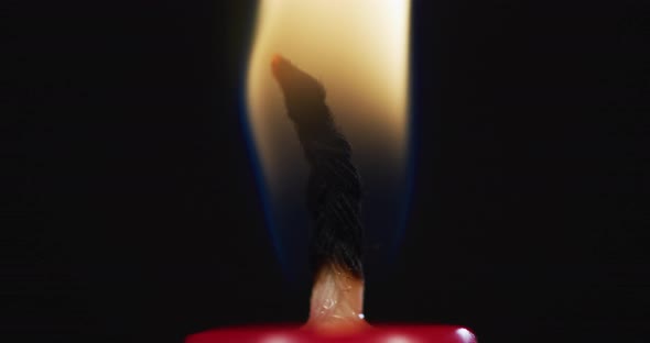 Extreme close up of a candle wick burning